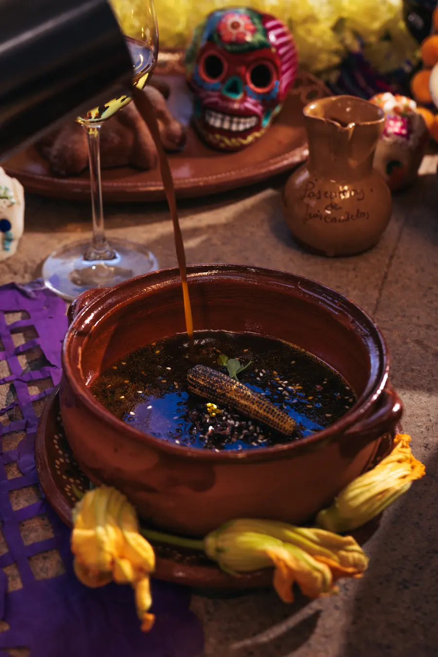 Milpa soup in a clay pot with squash blossoms