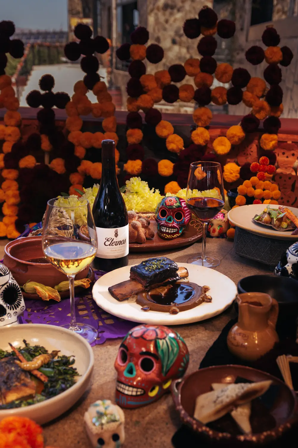 Table with a marigold altar, Eternos wine and the dinner courses
