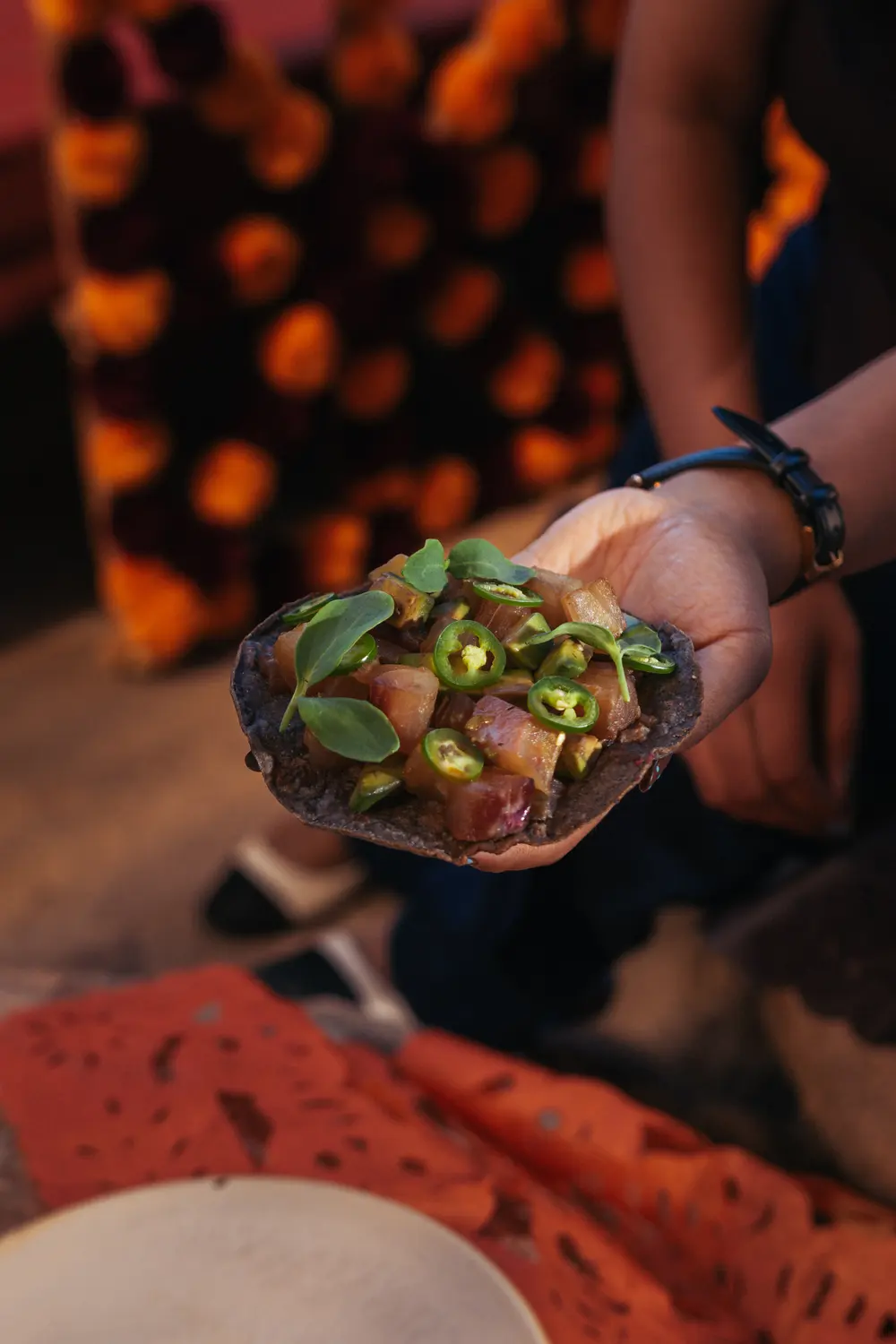 Blue corn tostada served at the table