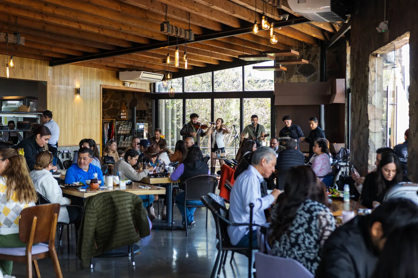 A full dining room with live music in the background