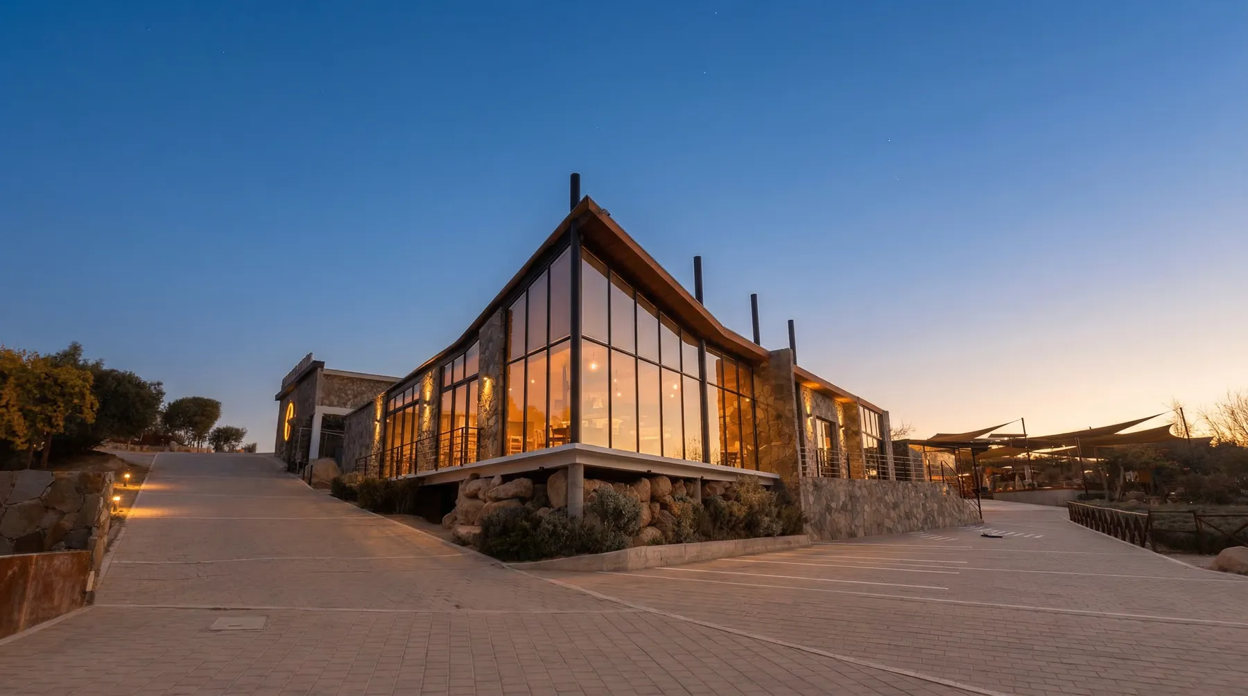 Salvia Blanca at sunset, its glass wall glowing over Valle de Guadalupe